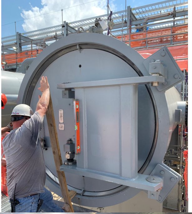 A technician swinging open a Bandlock 2 door in the field.