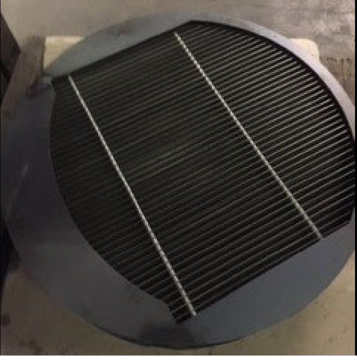 A round mesh pad on grid, banded for shipment.