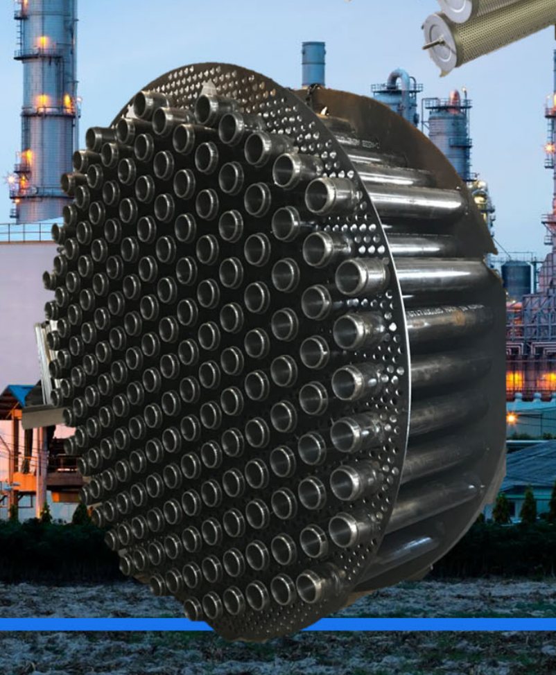 A stainless tubesheet face with several hundred drilled tube holes, staged outdoors at a refinery.